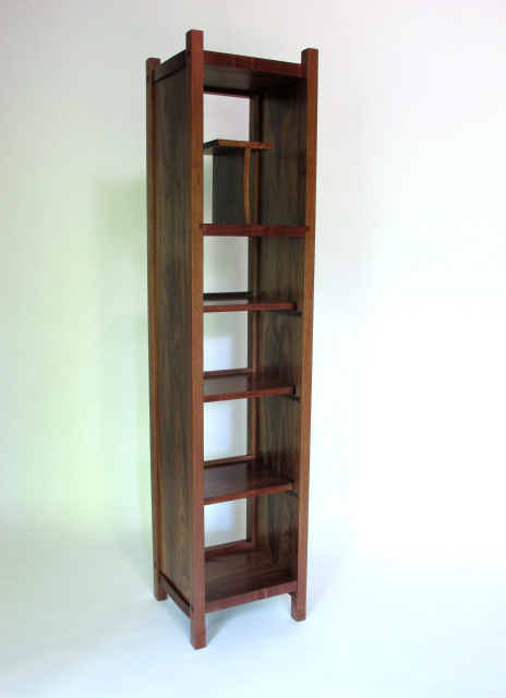 A tall narrow bookcase or display case with open shelving and artistic style - solid wood fine furniture